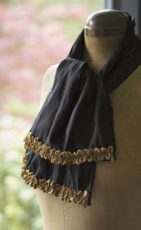 black silk scarf with gold ribbon trims and blue beads