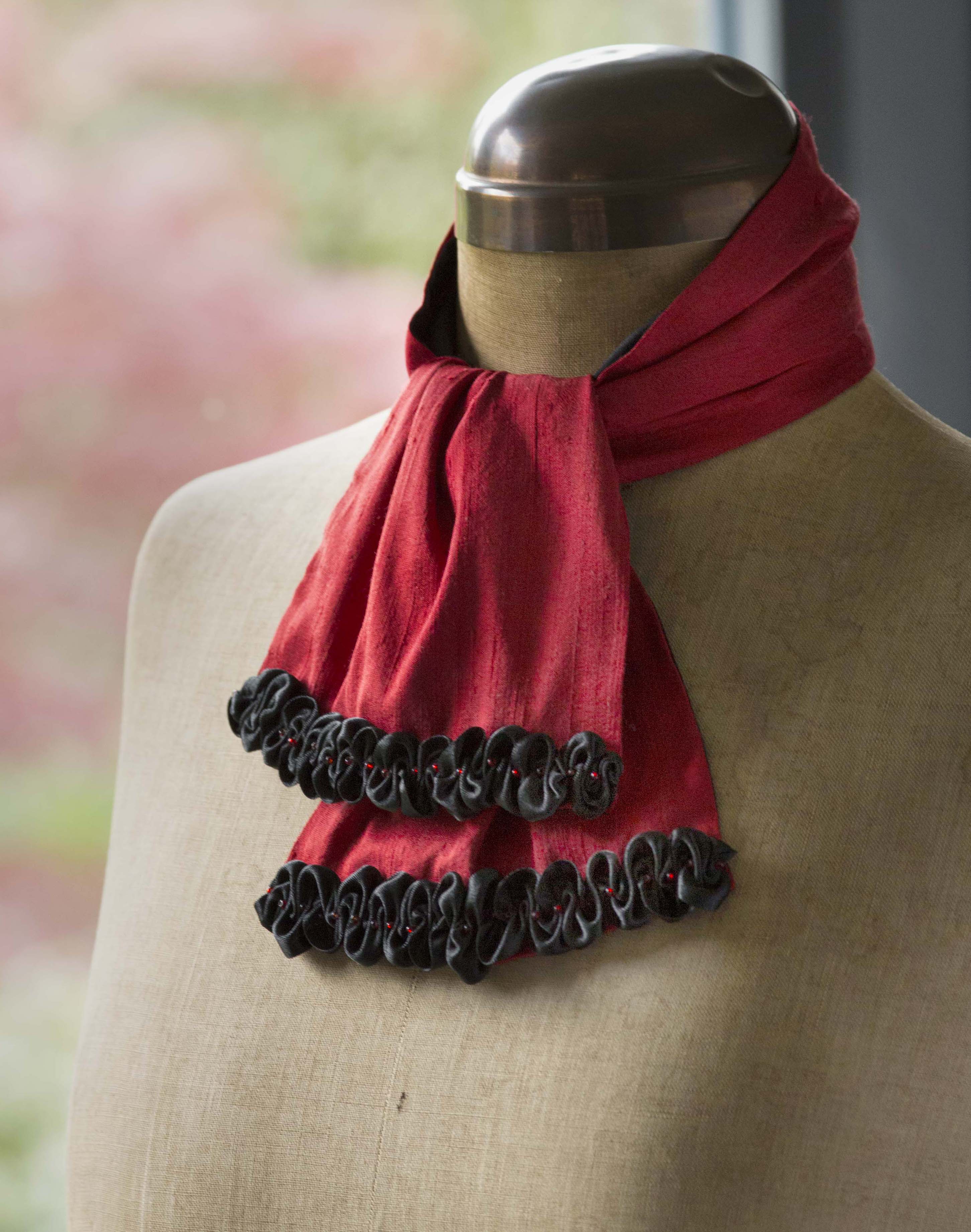 Red silk scarf with black ribbon trim